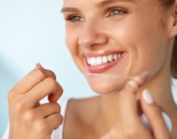 Dental Hygiene. Beautiful Woman Flossing Healthy White Teeth