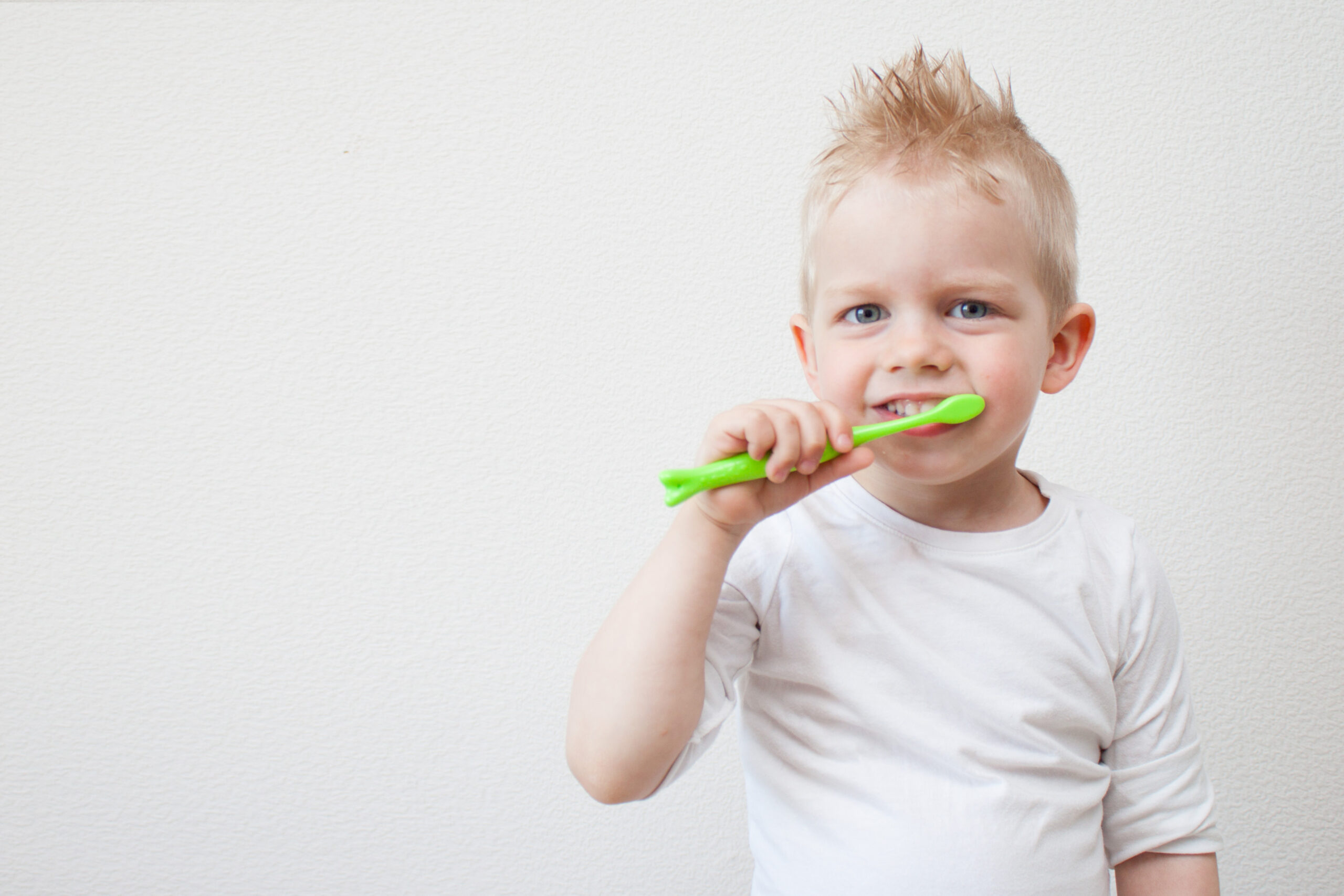kid boy brushing teeth